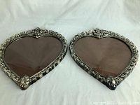 Pair of matching heart shaped picture frames side by side on white background
