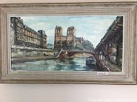 Framed oil painting of Notre Dame Paris with visible details and signature at bottom left.