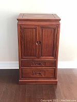 Front view of closed cabinet showing double doors and two drawers