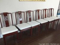 Row of six chairs against a wall showing overall set