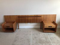 Full front view of headboard flanked by two nightstands on carpet