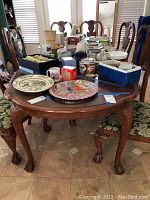 Dining table top covered with dishes and decorative items