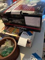 Photo showing stacked boxes including Calphalon Dutch Oven and Impress buffet range packaging