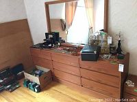 Full view of dresser and mirror set with some items on top of dresser to show size and condition