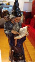 Front view of the Royal Doulton wizard figurine showing owl and book details