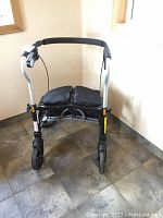 Front view of the walker showing seat, handles and wheel arrangement