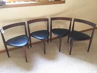 Overview of all four chairs arranged side by side under a window