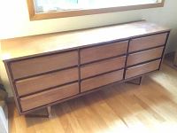 Front view of the nine-drawer wooden dresser showing drawer arrangement and surface wear.