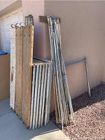Overall view: wooden planks stacked next to metal tubes