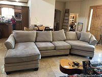 Full front view of three-piece sectional sofa in living area