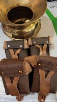 Brass spittoon with western horse tack stirrups featuring leather straps