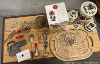 Top view of collection of vintage kitchenware including tools, utensils, canisters, and cutting board