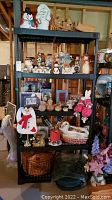 Full shelving unit capturing all items in the lot including Christmas figurines, candles, basket, backpack, faux floral, and other holiday decorations.