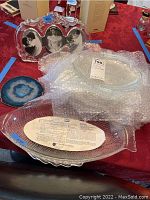 Overall view of all items together including the glass serving platter wrapped in bubble wrap, geode slice, and picture frame