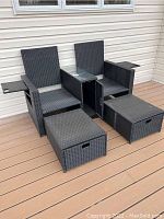 Full view of two-seat wicker settee, center console, side tables and two ottomans assembled