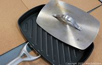 Calphalon panini pan and metal press set, showing pan's ridged surface and handle.