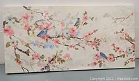 Full view of the large lightly textured picture showing birds perched on branches with pink and blue blossoms.