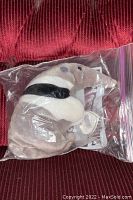 Ty Beanie Baby Ants plush in sealed plastic bag with tags visible, placed on red fabric background