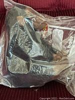 Ty Beanie Baby Congo monkey plush toy sealed in clear plastic bag, showing side angle with visible tags inside.