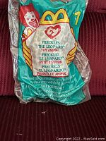 Photo of the front of the original plastic McDonald's packaging for Ty Beanie Baby Freckles the Leopard, showing McDonald's clown artwork and Ty logo.