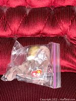 Ty Beanie Baby Jolly deer plush stored inside sealed plastic bag; item and tag visible