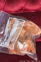 Brown and white plush Ty Beanie Baby fox stored inside a clear Ziplock plastic bag showing side profile