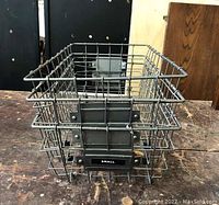 Stacked view of three wire baskets labeled small, medium, large showing dimensional differences and wire construction.