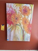 Colorful floral canvas art with predominantly yellow-orange flowers on a 24x36 canvas