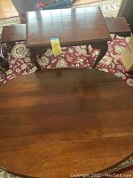 Top view showing the oval coffee table surface with drop-down side panels extended.