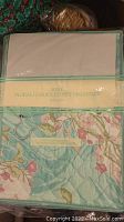 Front of the boxed Avon Floral Garden Closet Organizer with packaging showing the floral print and label.