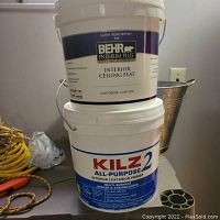 Two one-gallon containers stacked, top is Behr Premium Plus Ultra Pure White Interior Ceiling Flat paint and bottom is Kilz 2 All-Purpose Interior/Exterior Primer.
