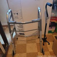 Silver aluminum walker with front wheels and padded hand grips