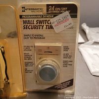 Photo of the Intermatic Wall Switch Security Timer in original sealed packaging, showing front of the unit and printed instructions.
