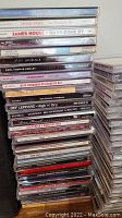 Stack of various music CDs showing titles from Shania Twain, James House, Ozzy Osbourne, Def Leppard, George Strait, and others.