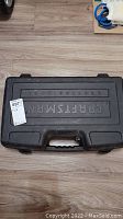 Closed black hard plastic carrying case with 'CRAFTSMAN' embossed on top.