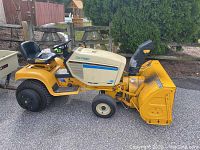 Left side view of Cub Cadet 1186 tractor with front snow blower attachment.