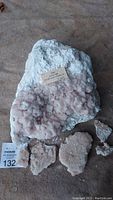 Largest halite crystal sample with five smaller pieces arranged below on surface, showing overall set size and condition.