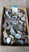 Box containing about 50 mixed thundereggs and nodules with various agate and mineral formations.