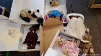 Five collectible bears displayed in original boxes including Annette Funicello bears and Boyd's Father Time bears with COAs and tags visible.