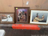 Photo of three framed Native American inspired art prints placed side by side against a wall, showing overall size and framing style.
