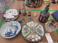 Wide view of figurines, ceramic dishes, and crystal lamp shade on table