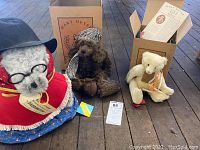 Three bears displayed: the Paddington bear on the left, Vincent brown mohair bear in the middle, and white Elizabeth bear on the right with its box behind.