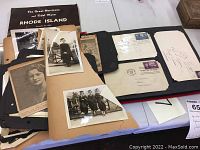 Collection of old family photos, letters, envelopes, postcards in scrapbook, and various paper ephemera