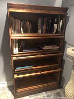 Front view of assembled four-tier barrister bookcase with books inside