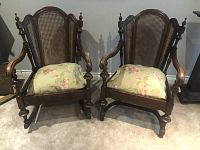 Both hardwood chairs side by side showing dark wood finish, cane backs, detailed craftsmanship, and floral seat cushions.