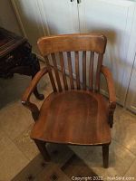 Front view of hardwood office chair showing curved backrest and armrests