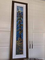 Full front view of framed painting showing mat and gold-tone frame