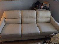 Full front view showing overall design, cushion layout, and legs.