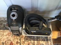 Front view showing vacuum body, hose and accessories