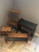 Photo showing four miscellaneous wooden stools and benches grouped together in corner.